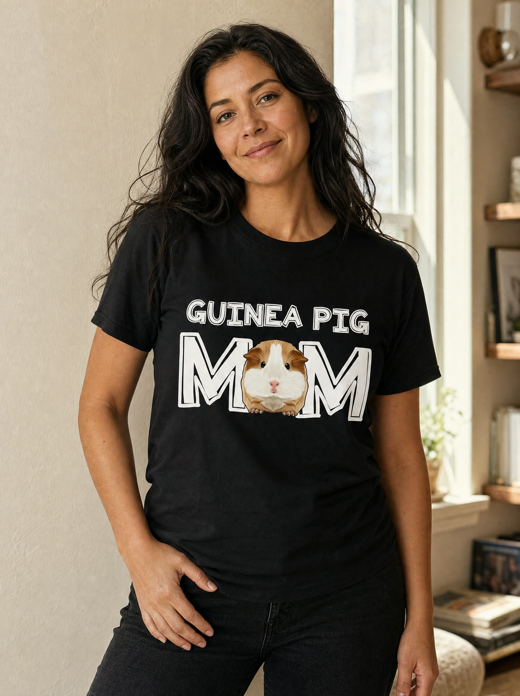 Guinea pig mom wearing the black Guinea Pig Mom tee in warm window light